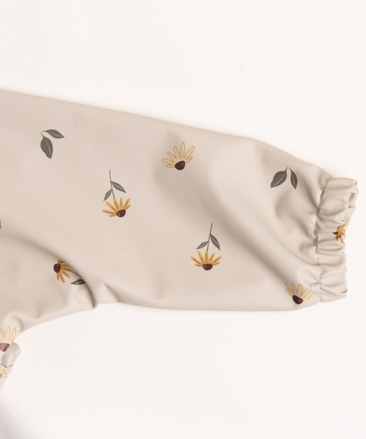 Haklapp med ärm & vattenavvisande ficka - Wildflower blossom Knatteplock